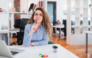 Decision Making Skills for Leaders: Thoughtful young businesswoman thinking of business problem solution at the workplace.